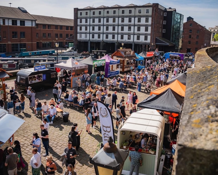 Looking down on the crowds attending Quayside Market in Sheffield on a sunny day 