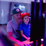 An adult and a child using a computer.