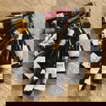 Seven bottles of wine arranged on a wooden surface.