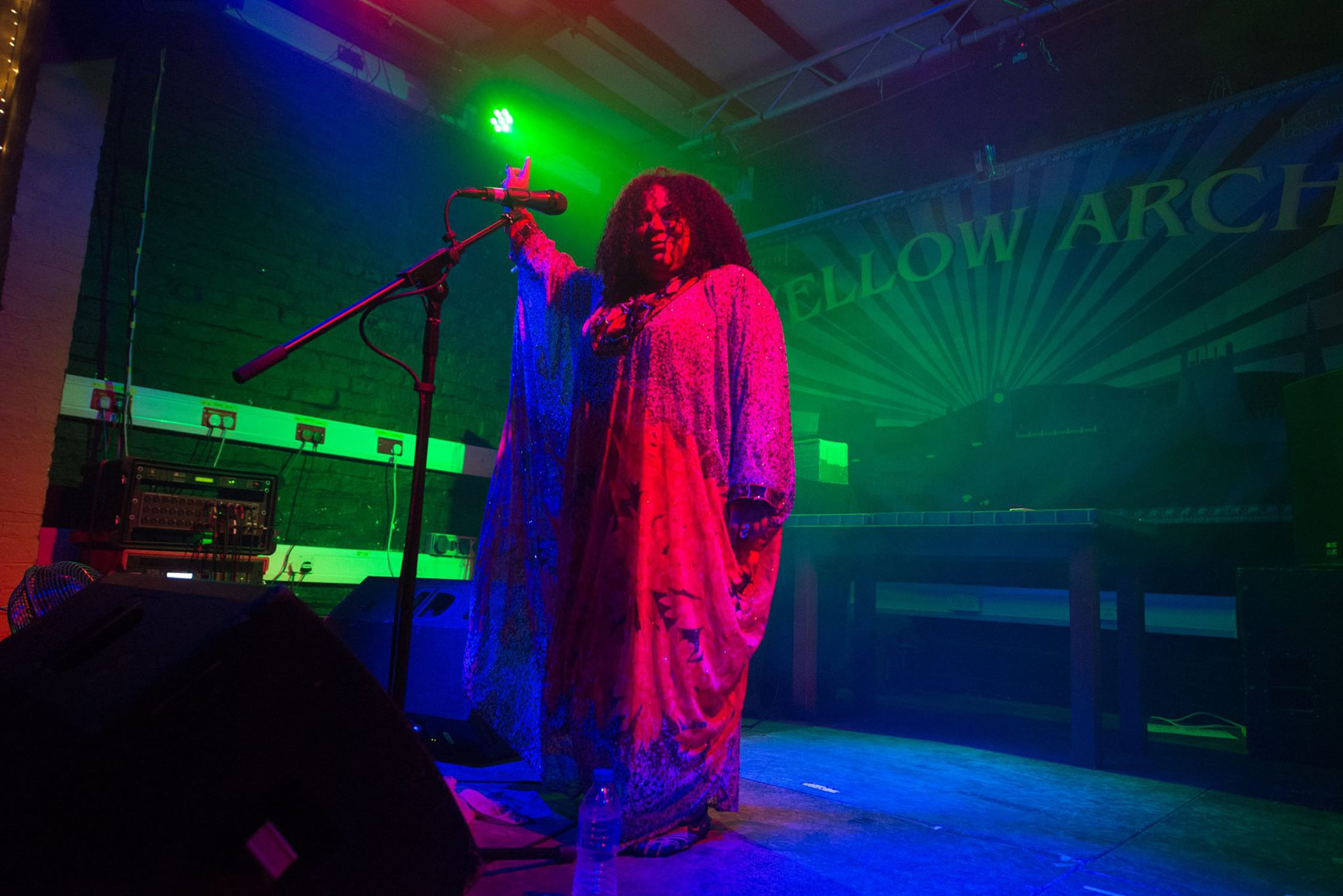 A woman sings live on the stage at Yellow Arch.
