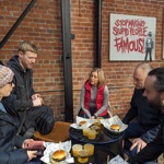 A group of people eating burgers on the Sheffield And Kelham Island Food Tour.