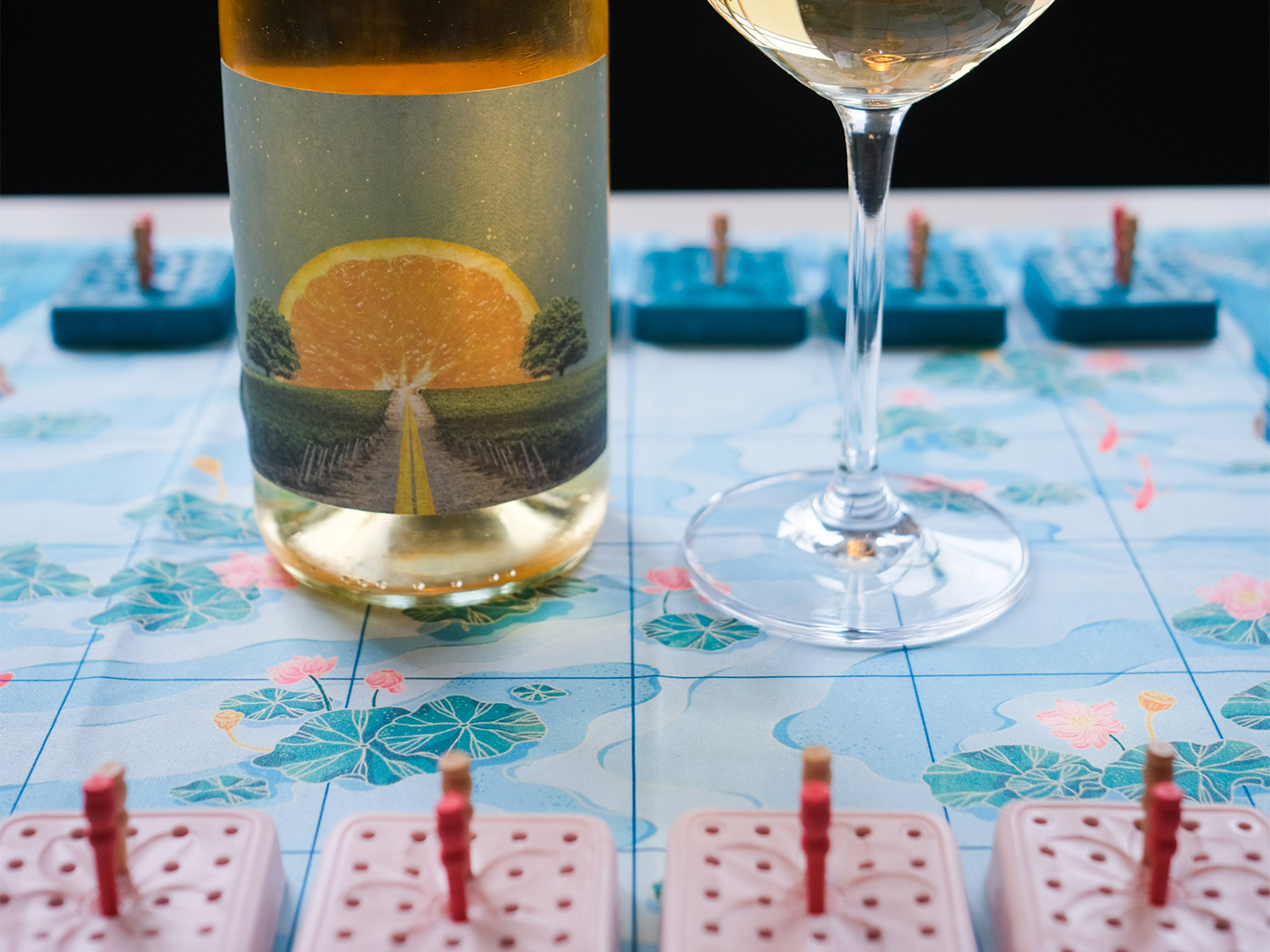 A table, at The Treehouse Cafe, with a glass of wine and a board game.
