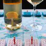 A table, at The Treehouse Cafe, with a glass of wine and a board game.