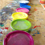 Six pots of screen printing ink.