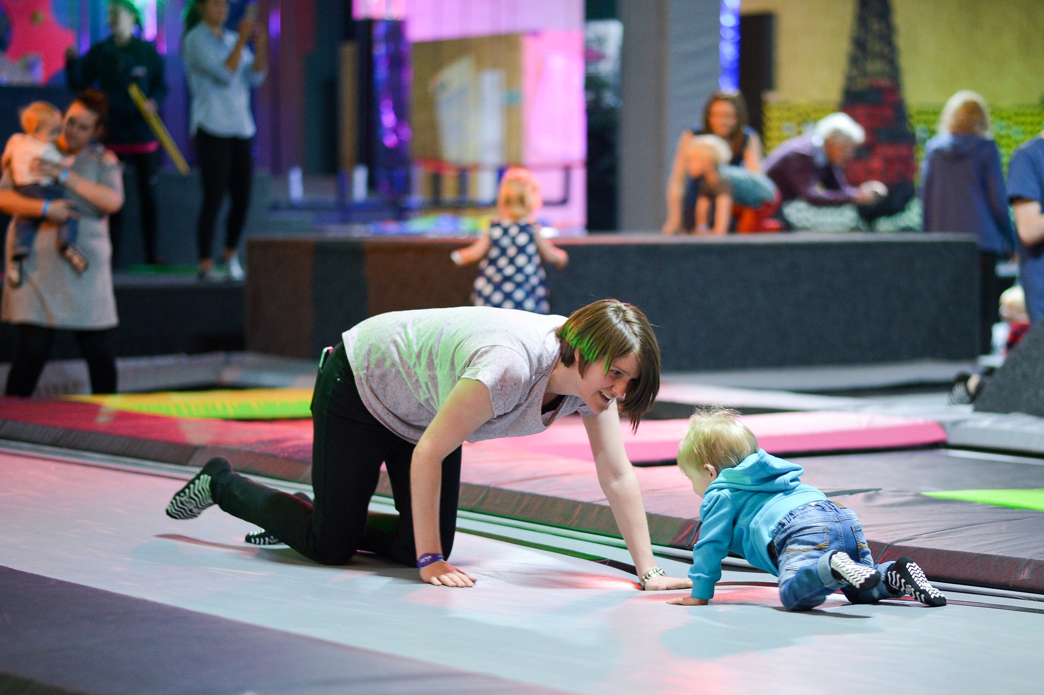 A woman and a small child playing and having fun at Jump Inc.