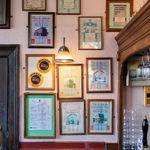 Interior of The Fat Cat; on the wall are lots of picture frames filled with mementos from the pubs past.