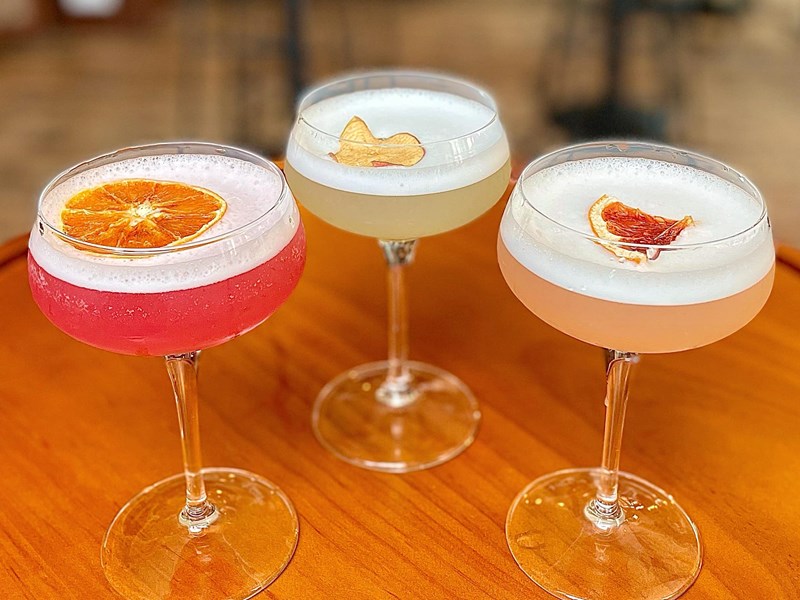 Three different gin cocktails on a table.