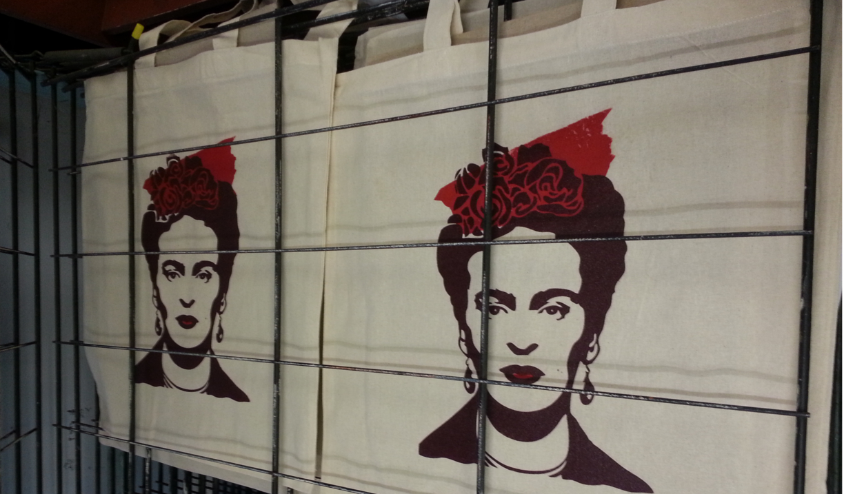 Totes bags drying on a rack having been screen printed.