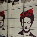 Totes bags drying on a rack having been screen printed.