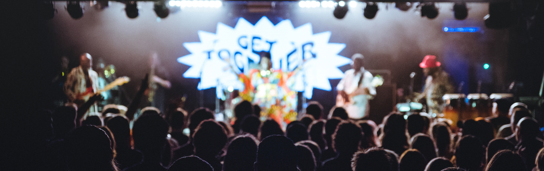 A crowd of people watch a band playing live on stage at the Get Together festival in Sheffield.