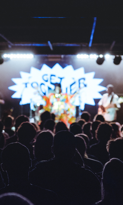 A crowd of people watch a band playing live on stage at the Get Together festival in Sheffield.