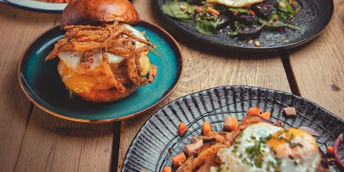A table with lots of different dishes at The Grind Cafe.