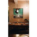 The interior of Restaurant Elm with a table laid out for two, under a large painting.