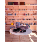 Interior shot of The Stylists Lifestyle Store with a table and shelving displaying various house wares.