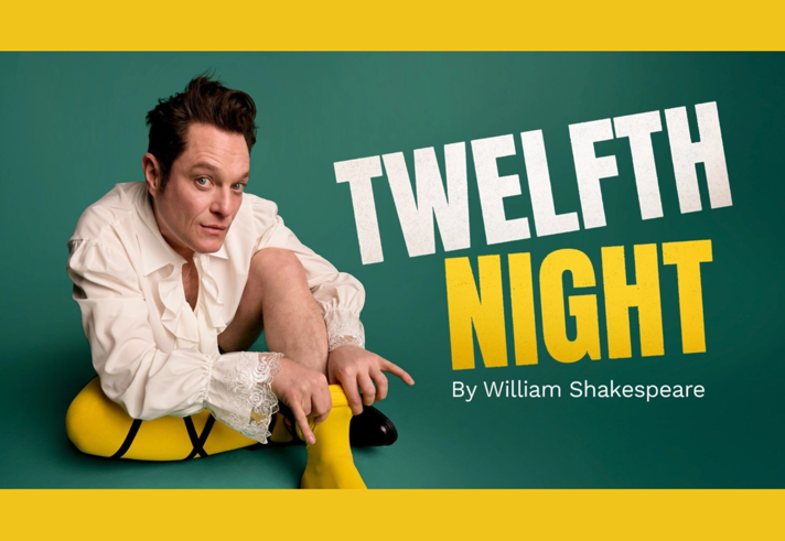 A promo fpr Twelfth Night, with a man sat on the floor putting on a pair of yellow tights.