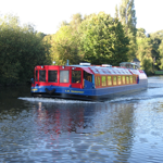 A leisure boat cruising along a canal.  