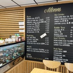 an image that shows the desserts in the display window and on the sign a large blackboard which has the menu on it