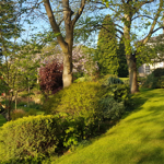 Beautiful landscaped grounds surrounding Halifax Hall Hotel with trees and gardens.