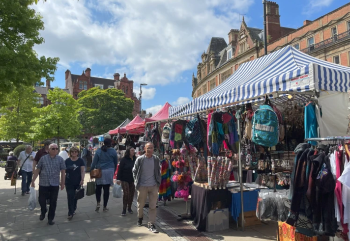 The Sheffield International Market from a previous year. Lots of people are looking around market stalls.
