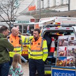 Members of the emergency services are chatting with members of the public on The Moor in Sheffield city centre. Children are looking at the emergency vehicles. 