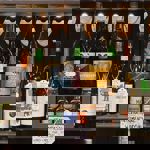 A shelf with various bottles of spirits.