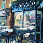 Table and chairs set out in the sun at Gills & Co.