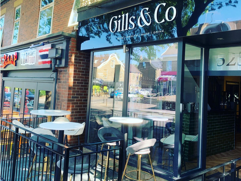 Table and chairs set out in the sun at Gills & Co.