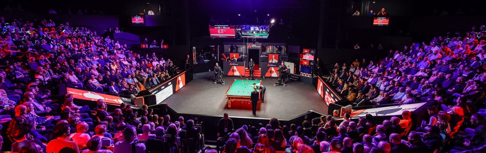 interior of the Crucible theatre showing audiences watching the World Snooker Championship 