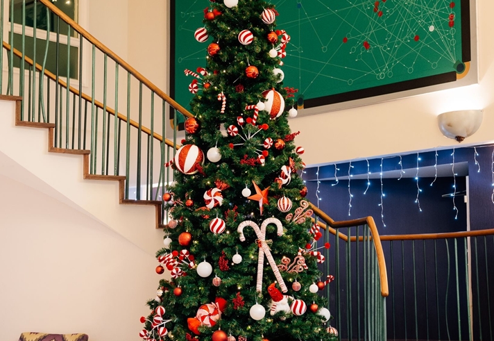 A dressed Christmas tree in the lobby of Mercure Sheffield Kenwood Hall Hotel & Spa.