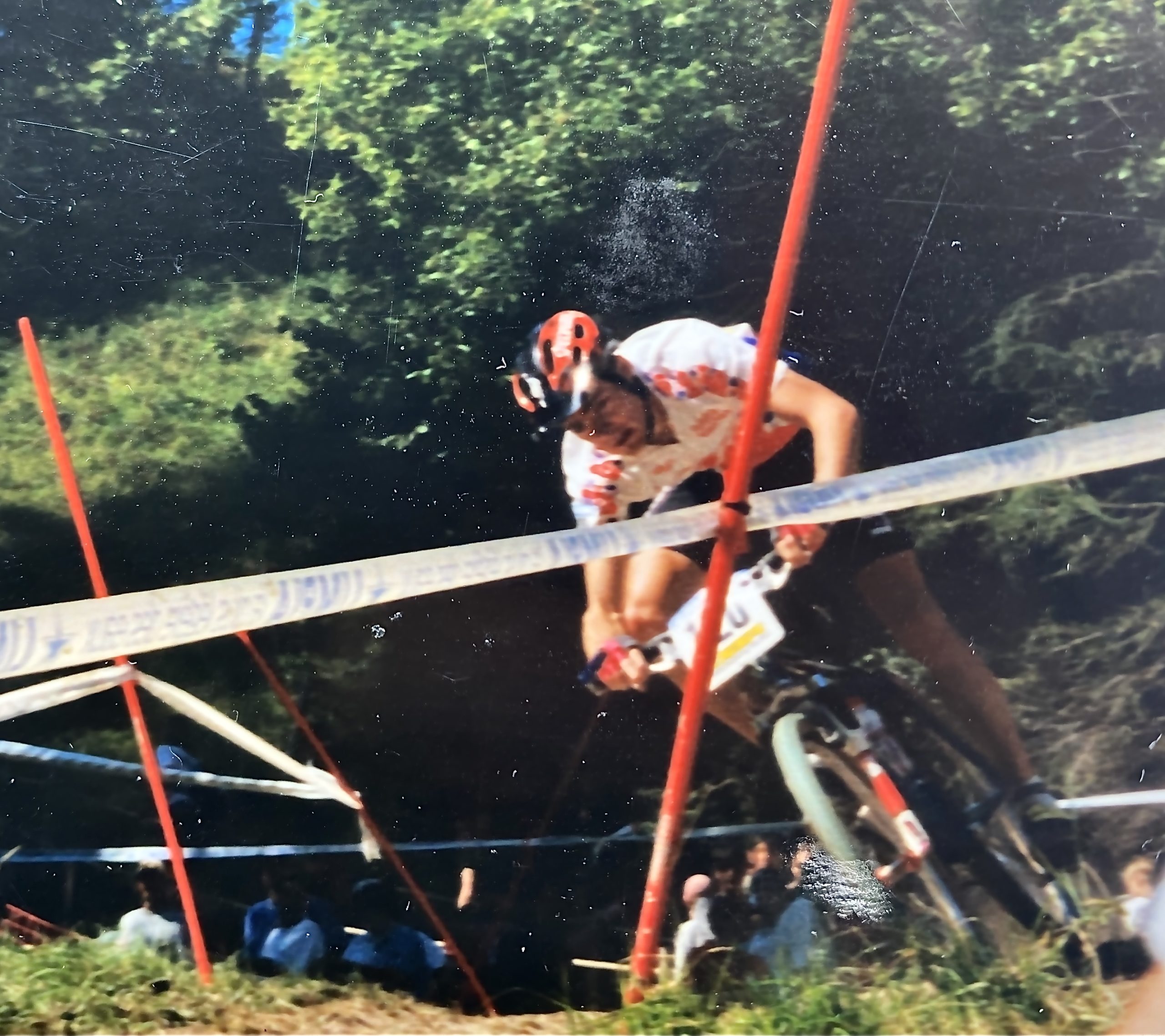  A person racing round a track on a mountain bike.