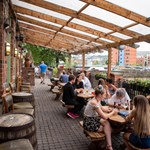 People drinking on the outdoor terrace at The Riverside Kelham.