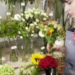 A member of staff arranging flowers at Plantology.