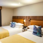 Twin bedroom at Mercure Tankersley Manor with two single beds, bedside tables, and soft lighting.